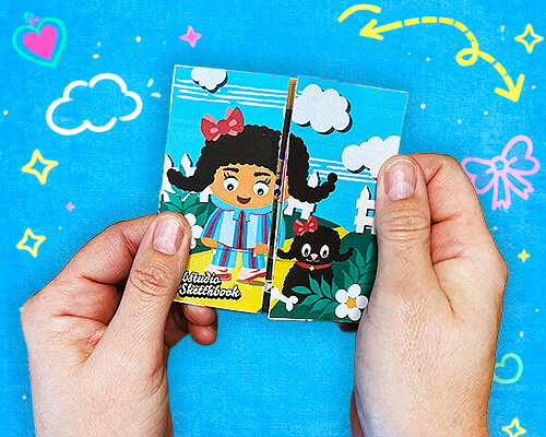 Hands holding an illustrated never-ending card featuring colorful characters and playful scenes.